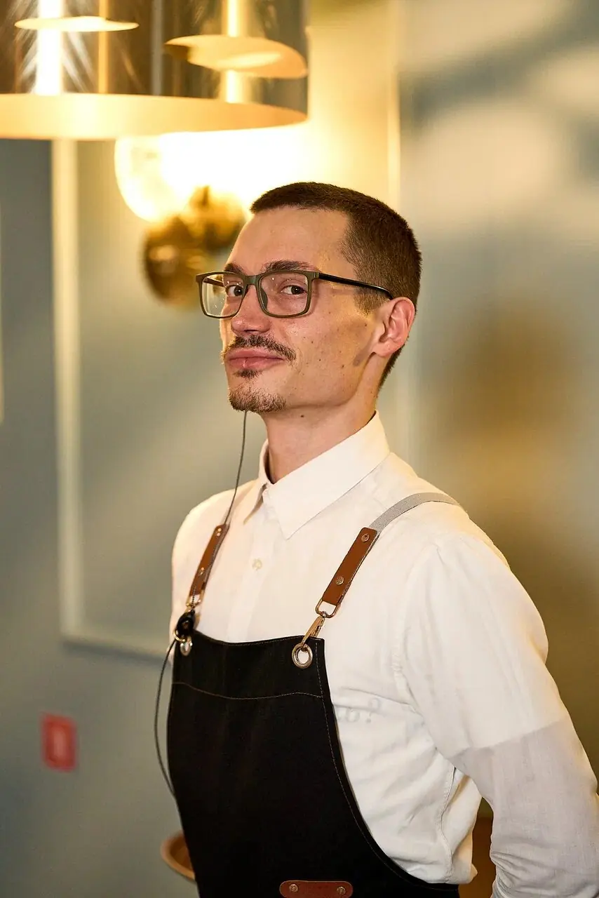 A smiling server in an apron